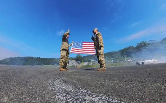 Sergeant Isaac Jimenez is taking his oath of reenlistment on the blacktop at Fuji Speedway