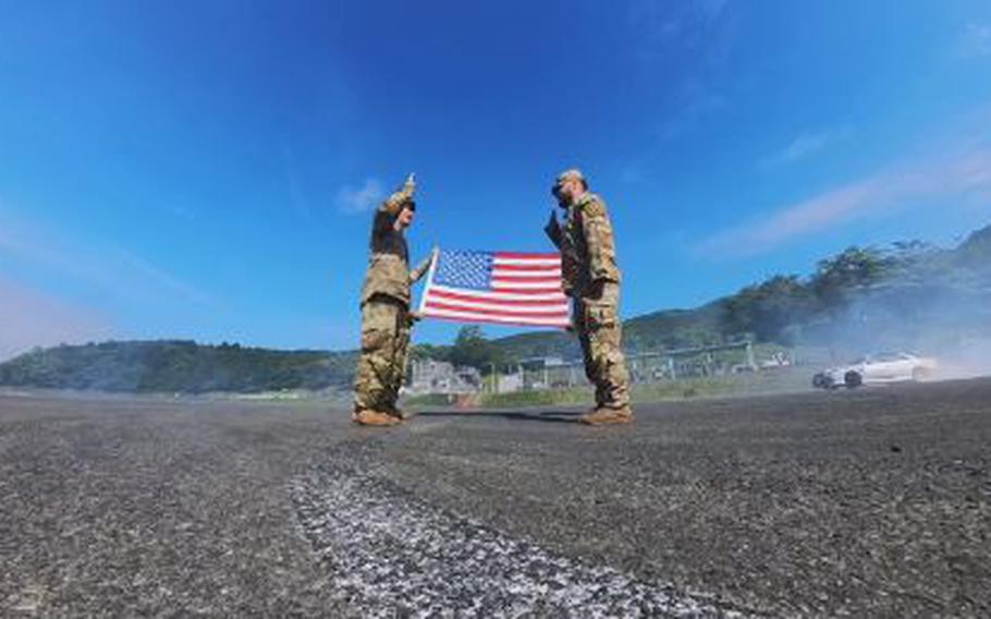 Sergeant Isaac Jimenez is taking his oath of reenlistment on the blacktop at Fuji Speedway