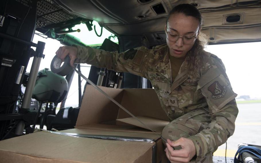 Tech. Sgt. Alexandra Vidato, 459th Airlift Squadron instructor flight engineer, tapes a box of simulated humanitarian aid prior to takeoff for a Tokyo Metropolitan Government hosted disaster preparedness and response drill at Tokyo Rinkai Disaster Prevention Park, Japan, Sept. 3, 2022. Taking off from Yokota Air Base, the 459th utilized a UH-1N Iroquois helicopter to deliver mock humanitarian aid after a simulated natural disaster. (U.S. Air Force photo by Tech. Sgt. Joshua Edwards)