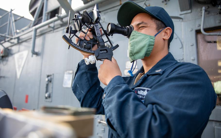 SASEBO (Aug. 05, 2020) - Quartermaster 2nd class Justin Ladrillono from Oceanside, California, demonstrates how to take a celestial measurement with a sextant aboard mine countermeasures ship USS Patriot (MCM 7). Patriot, part of Mine Countermeasures Squadron 7, is operating in the 7th Fleet area of operations to enhance interoperability with partners and serve as a ready-response platform for contingency operations. (U.S. Navy photo by Lt. j.g. Alexander Fairbanks)