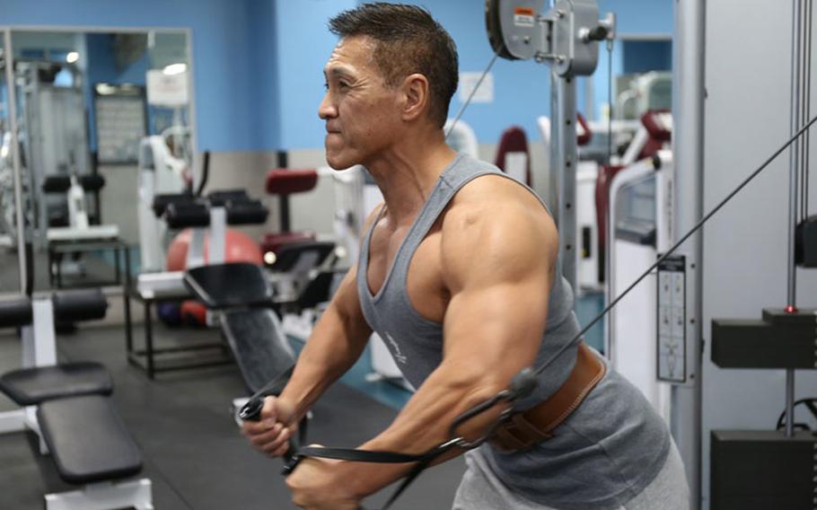 Kaoru Hashiguchi, an accounting technician with the 78th Signal Battalion at Camp Zama, Japan, works out Nov. 5 at the Yano Fitness Center there. Hashiguchi, 56, began training eight years ago to be a competitive bodybuilder and works out daily at Yano. (Photo Credit: Noriko Kudo, U.S. Army Garrison Japan Public Affairs)