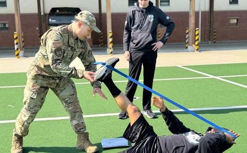 Photo Of U.S. Air Force Staff Sgt. Koji Yoshioka, 51st Operational Medical Readiness Squadron physical therapist technician, guides an individual through a strength and conditioning exercise during an Advanced Physical Training Leader course.
