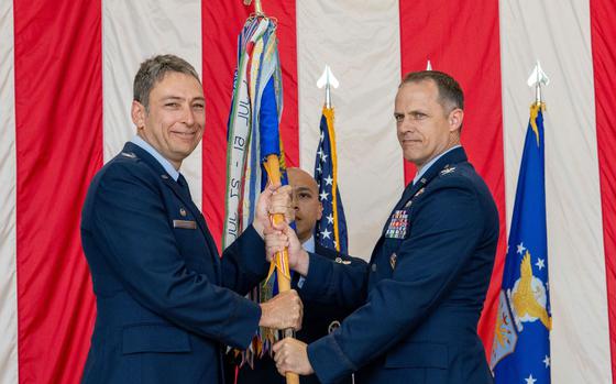 Photo Of From the left, U.S. Air Force Col. Andrew Roddan, 374th Airlift Wing commander, presents the 374th Operations Group guidon to Col. Nathan Powell, 374th OG incoming commander, as they take command during a change of command ceremony at Yokota Air Base, Japan, June 14, 2024.