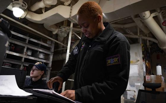 Operational Specialist Stefphanie Carothers, from Houston assigned to the forward-deployed amphibious assault ship USS America (LHA 6) manages paperwork in the ships aft hazmat