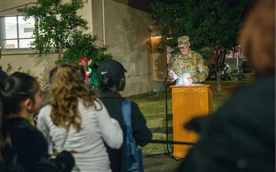 U.S. Air Force Col. Richard McElhaney, 374th Airlift Wing commander, speaks to a crowd during a tree lighting ceremony at Yokota Air Base, Japan, Dec. 2, 2024.