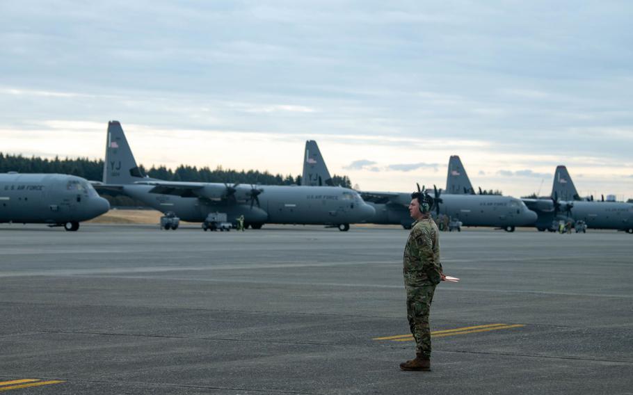 U.S. Air Force Senior Airman Giovanni Elias, 374th Aircraft Maintenance Squadron flight crew chief, waits to marshal a C-130J Super Hercules assigned to the 36th Airlift Squadron during exercise Airborne 24 at Yokota Air Base, Japan, March 7, 2024.