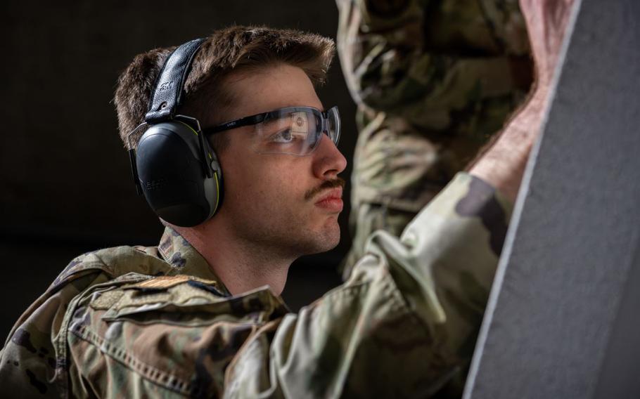 U.S. Air Force Senior Airman Ty Thomas, 35th Security Forces Squadron alarm monitor, checks shot groupings during a Combat Arms Training and Maintenance Excellence in Competition event held in honor of Police Week at Misawa Air Base, Japan.