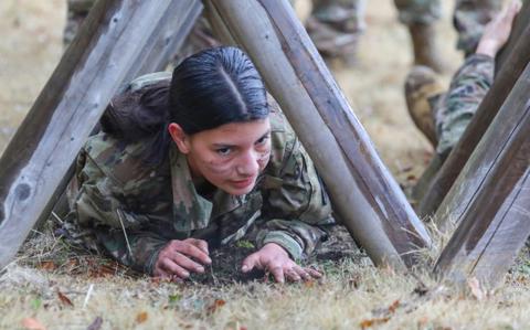 Photo Of Cadet Chelsea Sanchez crawls through an obstacle while completing a confidence course at Camp Zama, Japan, March 12, 2024.