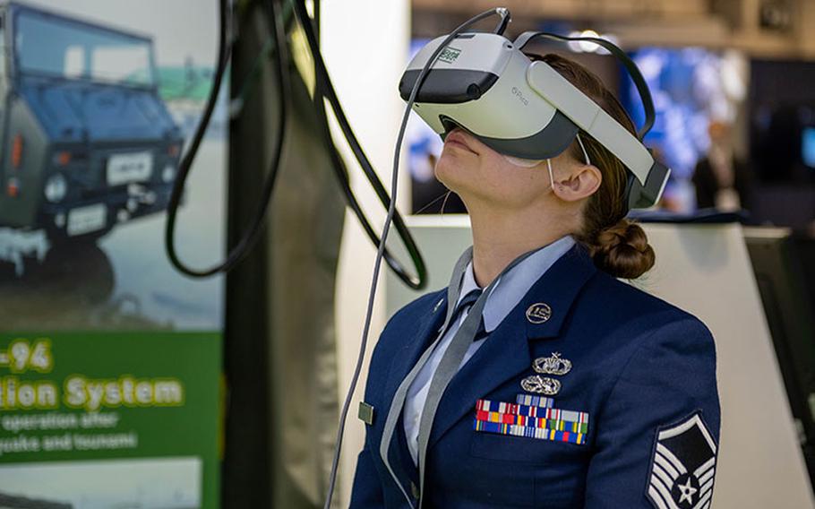 Master Sgt. Sarah Hubert, 374th Airlift Wing religious affairs superintendent, wears a virtual reality headset at the Defense and Security Equipment International (DSEI) Japan exhibition in Tokyo, March 16, 2023. With 66 countries represented, DSEI Japan is the largest defense exhibition in the country, attracting 178 companies vying for international business opportunities in the Asia-Pacific market. (U.S. Air Force photo by Airman 1st Class Natalie Doan)