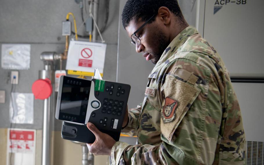 U.S. Air Force Senior Airman Nigél Jessamy, 374th Communications Squadron network infrastructure technician, assembles a telephone during Adamantium Shield II at Marine Corps Air Station Iwakuni, Aug. 21, 2024.