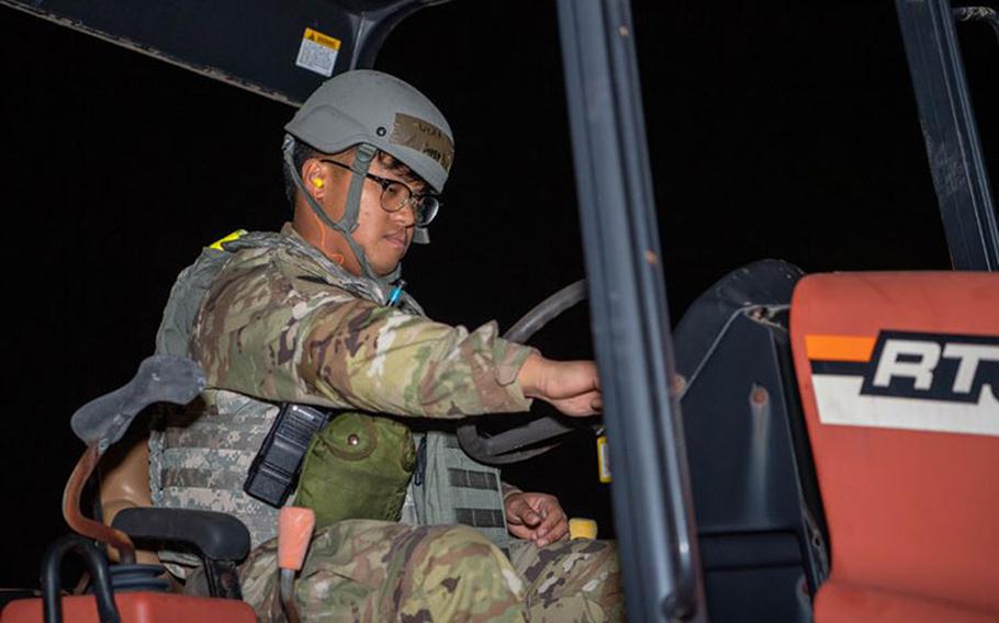 U.S. Air Force Staff Sgt. Jared Binoya, 374th Communications Squadron cable and antenna technician, starts the ignition of a tractor during Exercise Beverly Morning 24-1 at Yokota Air Base, Japan, Oct. 23, 2023. As the primary airlift hub in the Indo-Pacic region, the 374th Airlift Wing exercises regularly to ensure Airmen maintain their readiness to respond to any contingency at any time. (U.S. Air Force photo by Airman 1st Class Natalie Doan)