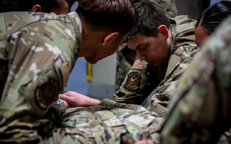 U.S. Air Force Airman 1st Class Remington Shafer, right, 35th Dental Squadron dental assistant, supports a stretcher transfer during a home station medical response training at Misawa Air Base, Japan.