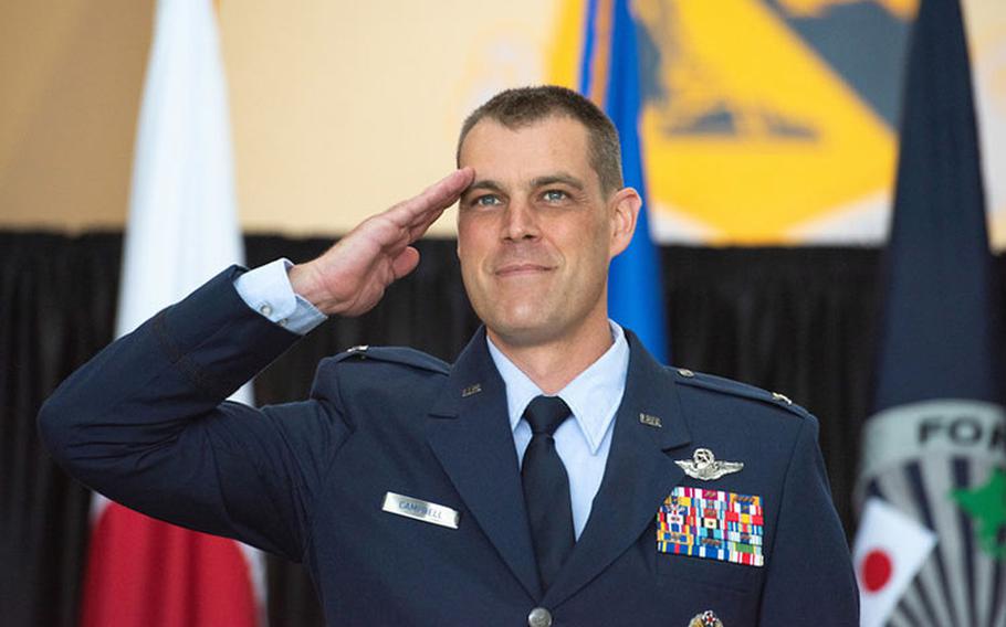 Col. Andrew J. Campbell, 374th Airlift Wing incoming commander, salutes after his name was unveiled on the wing's flagship C-130J Super Hercules during an assumption of command ceremony at Yokota Air Base, Japan, June 22, 2020. Having previously served as the 36th Airlift Squadron commander, Col. Campbell is accompanied by his wife Katie and their son, Ford, this assignment marks the third time the Campbell family will be stationed at Yokota. (U.S. Air Force photo by Machiko Arita)