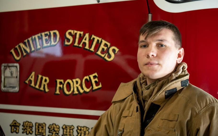 U.S. Air Force Senior Airman Ethan Embrey, 35th Civil Engineer Squadron firefighter poses in front of a Fire Engine at Misawa Air Base, Japan, Jan. 16, 2024. For his life-saving actions during the COPE North Exercise, Embrey was awarded the Senior Master Sergeant Robert A. McAllister Firefighter Heroism award at the Pacific Air Forces level. (U.S. Air Force photo by Airman 1st Class Patrick Boyle)