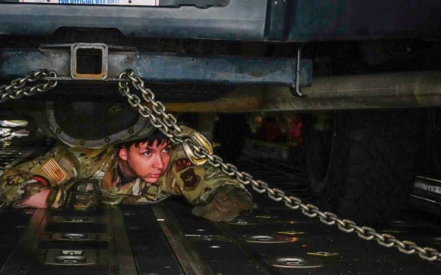 U.S. Air Force Staff Sgt. Dustin Cote, assigned to the 730th Air Mobility Squadron, ensures a truck is correctly chained down during the 515th Air Mobility Operations Group Port Dawg Rodeo at Yokota Air Base, Japan on March 1, 2023. (U.S. Air Force Air Force photo by Technical Sgt. Troy McCray)