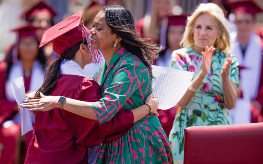 Renee Cobb the principal Matthew C. Perry High School hugs a member of the graduating class during a ceremony at Marine Corps Air Station Iwakuni, Japan, May 21, 2023. Biden visited MCAS Iwakuni as part of the Joining Forces initiative which focuses on supporting veteran families, caregivers, and survivors. (U.S. Marine Corps photo by Cpl. Raymond Tong)