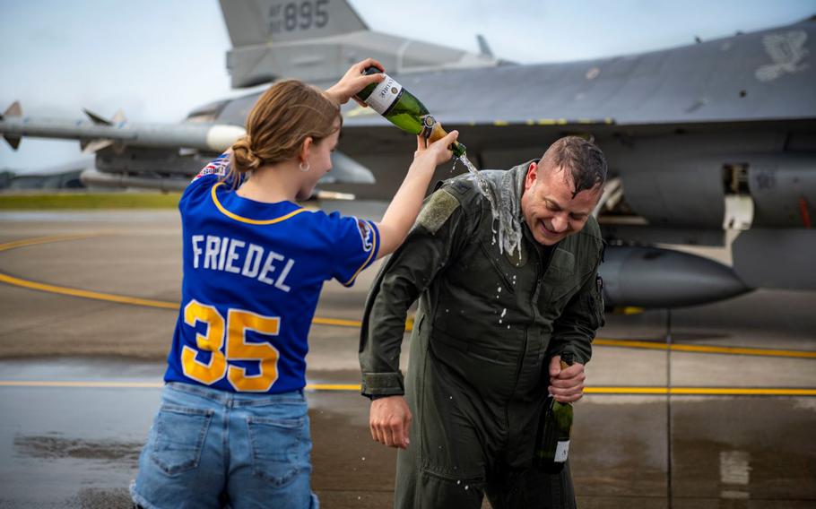 U.S. Air Force Col. Jesse J. Friedel, 35th Fighter Wing (FW) commander, gets sprayed with champagne by his daughter after his fini-flight at Misawa Air Base, Japan, June 22, 2022. Family and service members across the 35th FW and from the Japan Air Self-Defense Force attended Friedel’s fini-flight to celebrate and show support before his departure from Misawa. (U.S. Air Force photos by Airman 1st Class Leon Redfern)