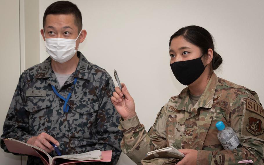 Tech. Sgt. Kanako Fromm, 374th Logistics Readiness Squadron decentralized materiel support section chief, translates for a member of the Japan Air Self-Defense Force during a bilateral civil engineer key leader engagement in the Emergency Operations Center at Yokota Air Force, Japan, Oct, 20, 2022. The visit helped familiarize the U.S. and Japan forces in command and control during a contingency or major humanitarian assistance in natural disaster events. (U.S. Air Force photo by Machiko Arita)