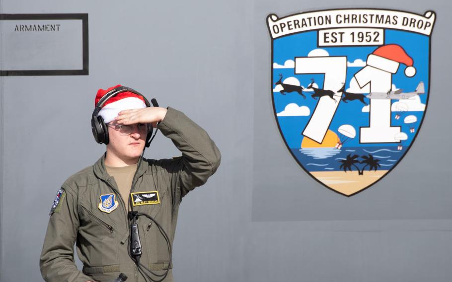 U.S. Air Force Airman 1st Class Riley Henagar, 36th Expeditionary Airlift Squadron C-130J loadmaster, looks at the flightline at Andersen Air Force Base, Guam, Nov. 30, 2022, during Operation Christmas Drop 2022. The 36th EAS, subordinate to the Expeditionary Operations Group, activated as of Nov. 16, 2022 and is tasked to execute airdrop operations in support of OCD 2022. (U.S. Air Force photo by Yasuo Osakabe)