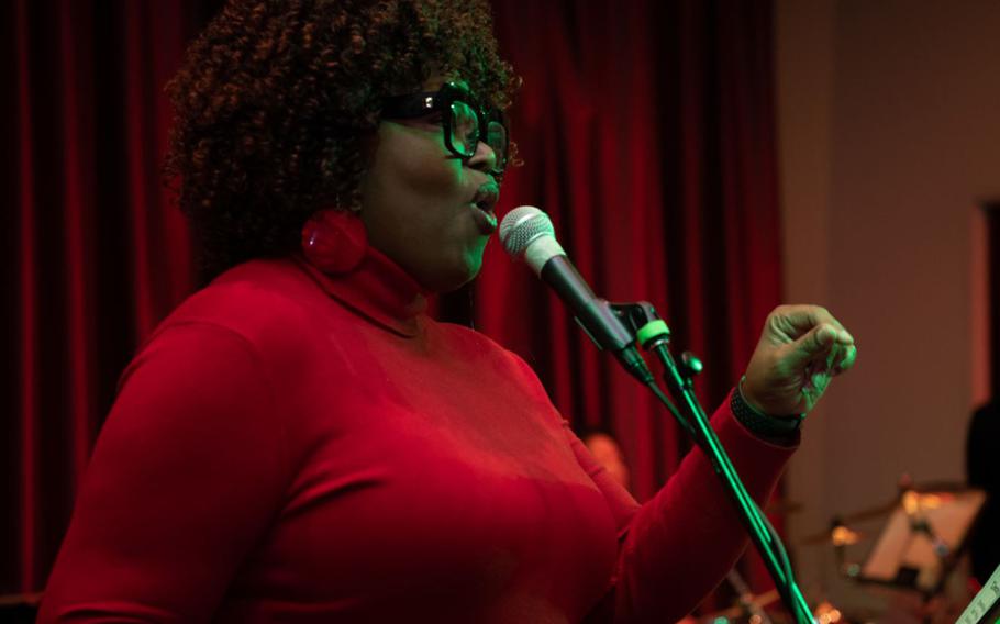 Ms. Marietta Epps-Williams sings Christmas carols at the Force Support Squadron's Christmas market at Yokota Air Base, Japan, Dec. 8, 2022. Yokota hosted a Christmas market, where the base community participated in holiday themed events. Face painting, live music, photos with Santa and food were some of the activities offered for participants to enjoy. (U.S. Air Force photo by Airman 1st Class Brooklyn Golightly)