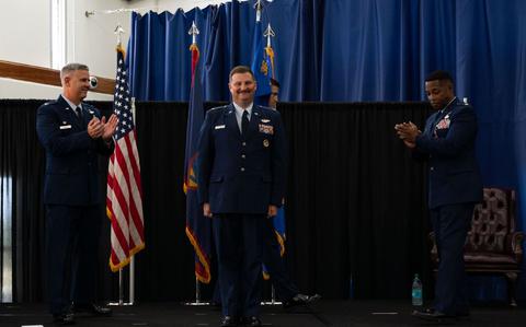 Photo Of U.S. Air Force Col. Thomas Bowman, 36th Operations Group commander, left, and Lt. Col. Edwin Pratt, outgoing 36th Operations Support Squadron commander, right, clap for Lt. Col. Micah McCracken, 36 OSS commander during a change of command ceremony.