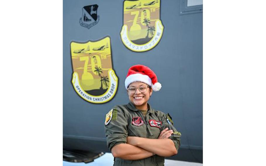 U.S. Air Force Senior Airman Kim Doyle, a loadmaster assigned to the 36th Airlift Squadron, Yokota Air Base, Japan, poses for a portrait in front of a U.S. Air Force C-130J during Operation Christmas Drop at Andersen Air Force Base, Guam, Dec. 10, 2021. OCD is the Department of Defense’s longest-running humanitarian airlift operation, beginning in 1952. Today, airdrop operations include more than 55 islands throughout the Pacific. (U.S. Air Force photo by Senior Airman Aubree Owens)