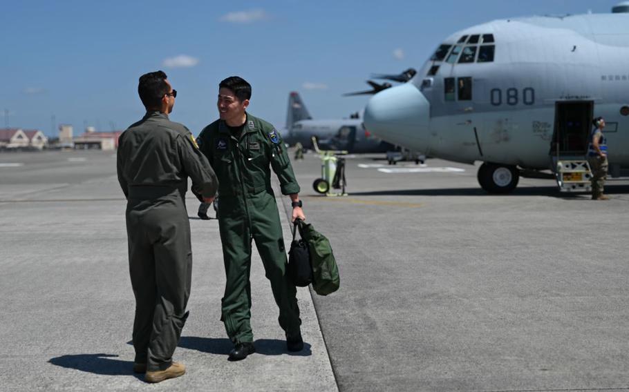 U.S. Air Force Capt. Simon Castro, 36th Airlift Squadron training officer, greets Japan Air Self-Defense Force Capt. Kenta Maruyama, 401st Tactical Airlift Squadron C-130H Hercules co-pilot, during a subject matter expert exchange.