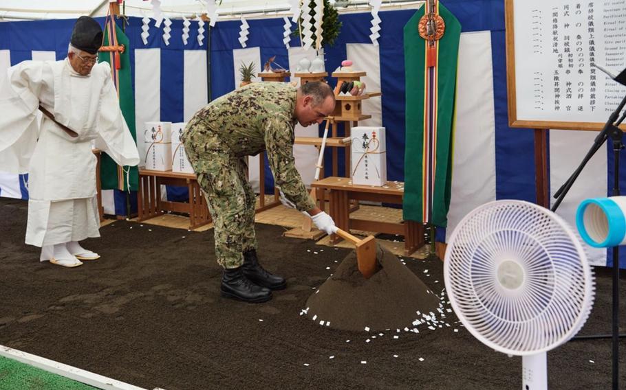 Capt. Jonathan Hopkins, commanding officer for Afloat Training Group (ATG) Western Pacific, participates in a Jichinsai at the site of the Ship Handling and Combat Training Facilities outside the ATG Building onboard Commander, Fleet Activities Yokosuka October 7, 2024.