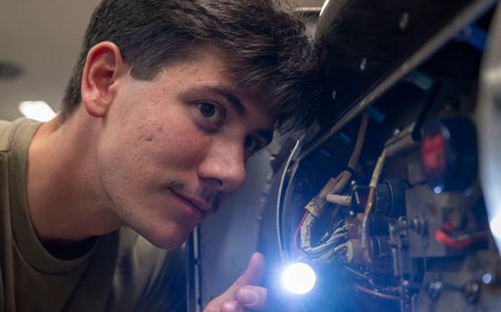 U.S. Air Force Airman Cameron DeGray, 35th Maintenance Squadron avionics flight electronic warfare systems technician, inspects an AN/ALQ-184 electronic countermeasures pod at Misawa Air Base.