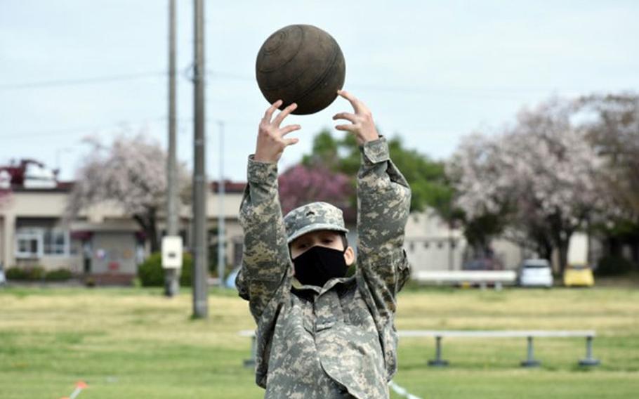 Cadet Cpl. Bryson Gummerus completes the standing power throw portion of the Army Combat Fitness Test during the Zama Middle High School Junior Reserve Officers’ Training Corps Cadet Leadership Challenge at Camp Zama, Japan, April 6. (Photo Credit: Photo by Winifred Brown)