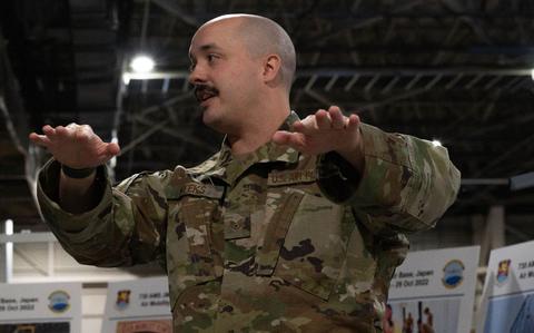 Photo Of U.S. Air Force Staff Sgt. Jeffrey Weeks, 730th Air Mobility Squadron air terminal operations center information controller, speaks to members of the Japan Air Ground Self-Defense Force about the significant missions of the 730th AMS at Yokota Air Base, Japan, March 22, 2024.