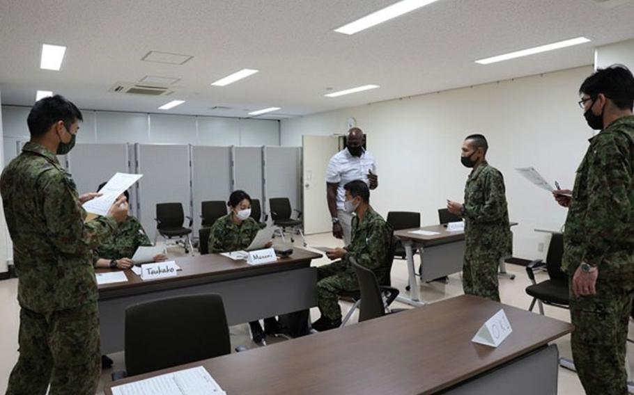 Rodney Holloway, an English for Speakers of Other Languages teacher at Arnn Elementary, checks on Japan Ground Self-Defense Force members as they practice English with partners Oct. 18 during the free weekly English-language class Holloway has hosted voluntarily on Camp Zama, Japan, since June. (Photo Credit: Noriko Kudo, U.S. Army Garrison Japan Public Affairs)