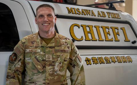 Photo Of U.S. Air Force Senior Master Sgt. Roger Halle, 35th Civil Engineer Squadron fire chief, poses in front of his fire chief truck at Misawa Air Base, Japan.