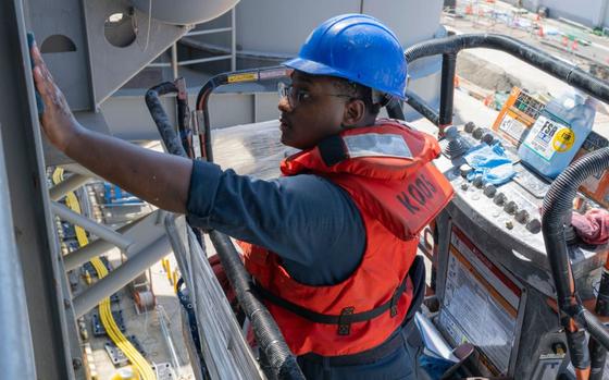 Photo Of Boatswain’s Mate 3rd class Kristopher Hoskins, from Gulfport, Mississippi, assigned to the forward-deployed amphibious assault ship USS America (LHA 6), performs restoration work on the ship’s side in Sasebo, Sept. 26, 2024. America, lead ship of the America Amphibious Ready Group, is operating in the U.S. 7th Fleet area of operations.