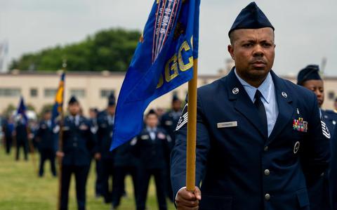 Photo Of U.S. Air Force Master Sgt. John Howard, 374th Surgical Operation Squadron flight chief, holds a guidon during an open ranks inspection at Yokota Air Base, Japan