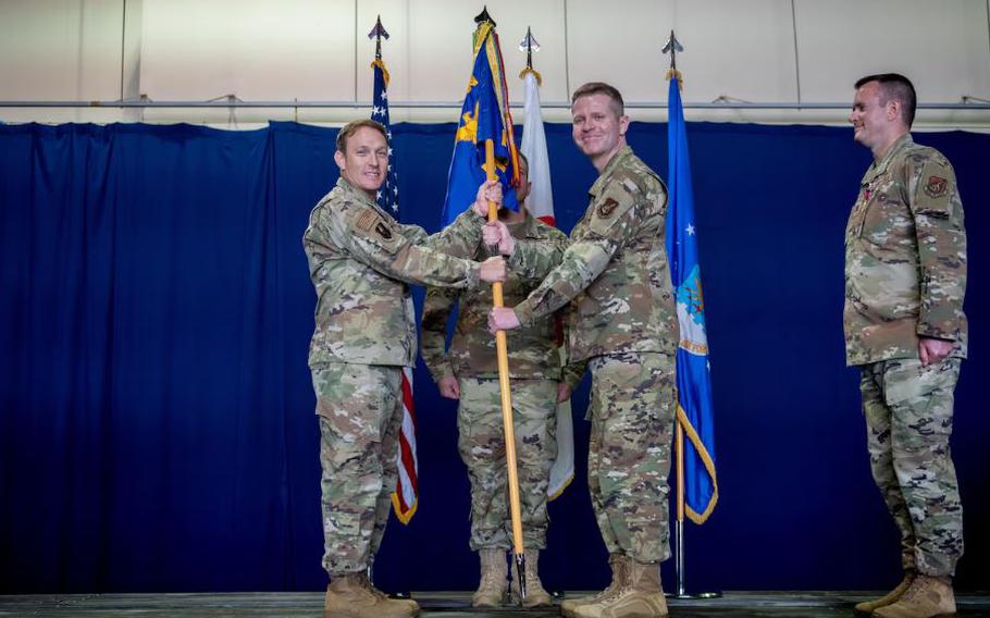 U.S. Air Force Col. Paul Davidson, 35th Fighter Wing commander, passes the group guidon to U.S. Air Force Col. John Conner, incoming 35th Mission Support Group (MSG) commander, as part of a change of command ceremony at Misawa Air Base, Japan.
