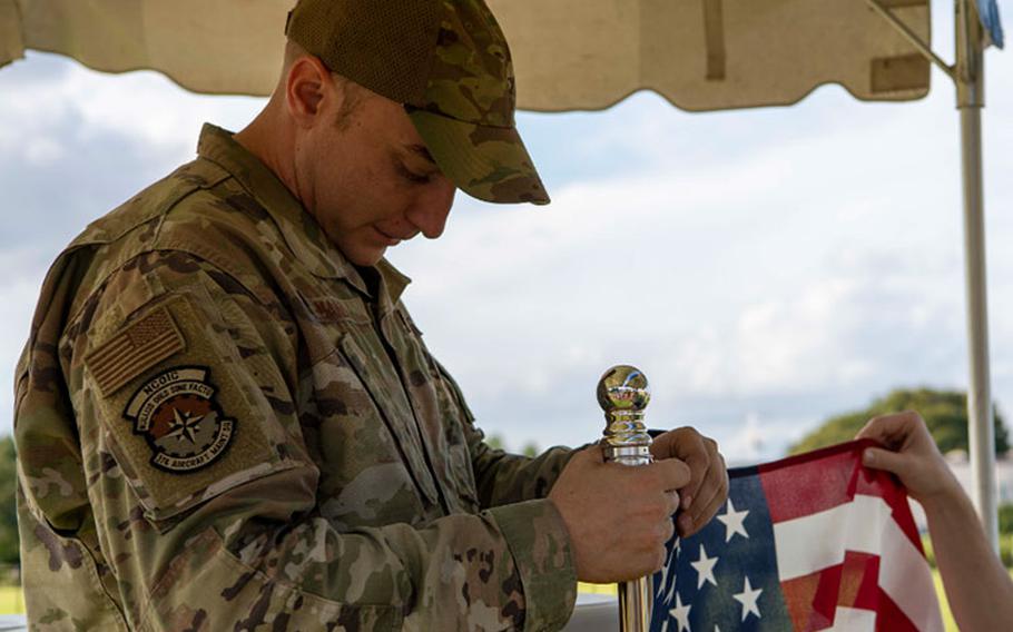 Tech. Sgt. Charles Manz, 374th Aircraft Maintenance Squadron crew chief NCO in charge, attaches the U.S. flag to a pole on Yokota Air Base, Japan, Sept. 14, 2023. Manz, a member of the Air Force Sergeant Association Chapter 1551, helped coordinate Yokota’s first-ever POW/MIA 24-hour remembrance run. (U.S. Air Force photo by Airman 1st Class Samantha White)