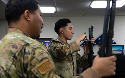 Photo Of From the left, U.S. Air Force Senior Airman Keshawn Carmen, 374th Security Forces Squadron base defense leader, and Senior Airman Eduardo Ortiz, 374th SFS counter small unmanned aircraft systems trainer, participate in the classroom portion of the Defender’s Qualification Course at Yokota Air Base.