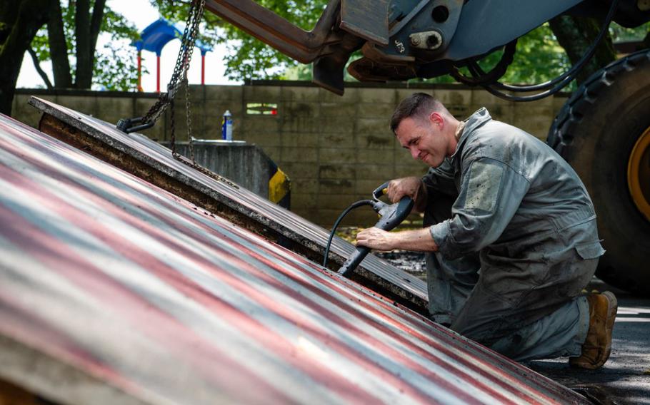 U.S. Air Force Master Sgt. Zachary Bieranowski, 374th Civil Engineer Squadron power production NCO in charge, conducts maintenance on an active vehicle barrier system at Yokota Air Base, Japan, Aug. 5, 2024.