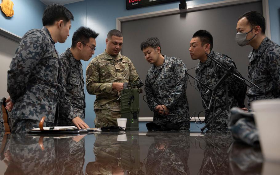 U.S. Air Force Senior Airman Kendrick Mercer, 35th Communications Squadron radio frequency transmission technician, demonstrates communications equipment usage for Japan Air Self-Defense (JASDF) Airmen during a Multi-Capable Airman (MCA) course at Misawa Air Base, Japan, March 5, 2024.