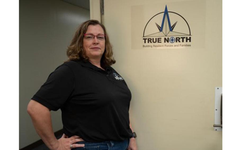 Rochelle Phelps, an embedded true north provider for the Wing Staff Agencies at Yokota Air Base, poses for a photo in front of a True North sign, May 19, 2023. True North is a resilience program that assigns mental health providers and religious support teams directly to Air Force squadrons, giving Service Members, DoD Civilians, and their authorized dependents increased access to care. (U.S. Air Force photo by Airman 1st Class Jarrett Smith)