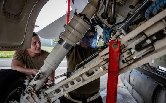 Photo Of U.S. Air Force Airman First Class Chloe Bruno, right, 13th Fighter Generation Squadron, or FGS, assistant dedicated crew chief, and Senior Airman Jacob Fisk, 13th FGS assistant dedicated crew chief, performs oil servicing on an F-16 Fighting Falcon during Valiant Shield 2024 at Misawa Air Base, Japan, June 10, 2024.