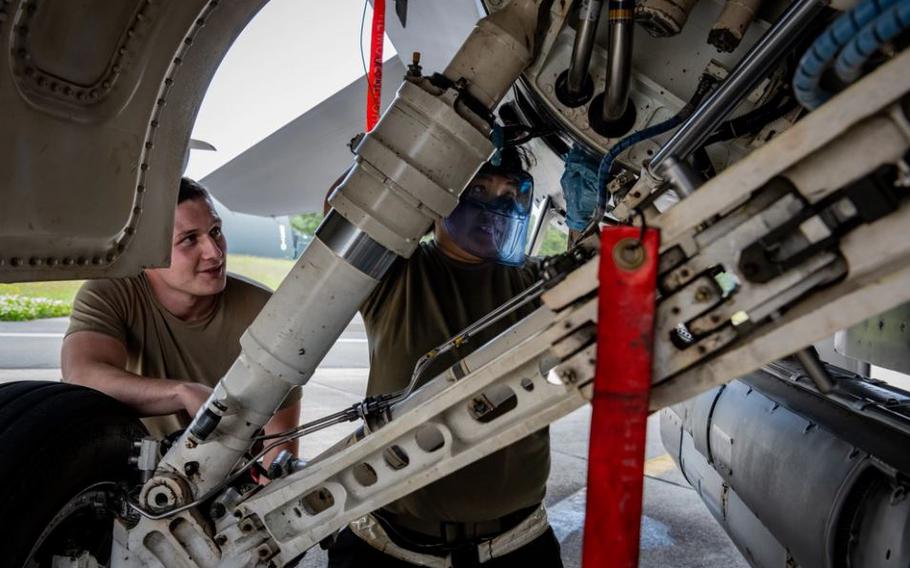 U.S. Air Force Airman First Class Chloe Bruno, right, 13th Fighter Generation Squadron, or FGS, assistant dedicated crew chief, and Senior Airman Jacob Fisk, 13th FGS assistant dedicated crew chief, performs oil servicing on an F-16 Fighting Falcon during Valiant Shield 2024 at Misawa Air Base, Japan, June 10, 2024. 