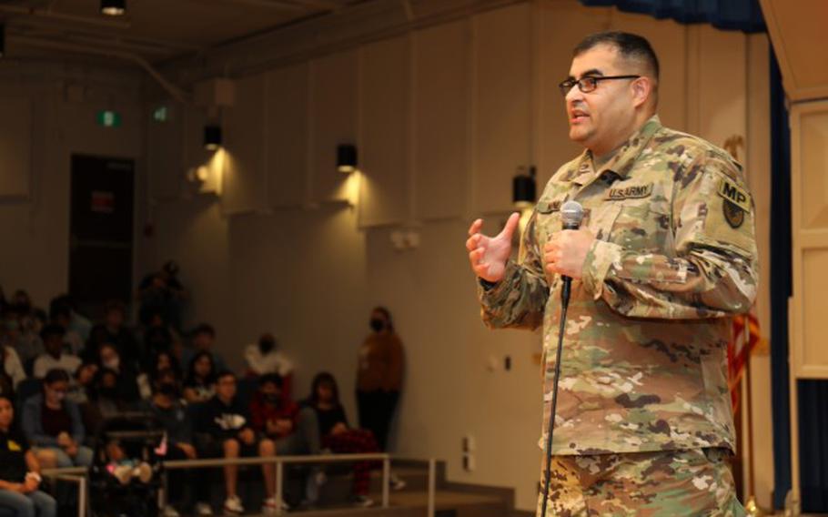 Staff Sgt. Benigno Nunez, assigned to the 88th Military Police Battalion, shares his personal experiences of witnessing the deadly consequences of drugs and excessive alcohol use with students during a Red Ribbon Week assembly inside the Zama Middle High School auditorium at Camp Zama, Japan, Nov. 3, 2022. (Photo Credit: Sean Kimmons)