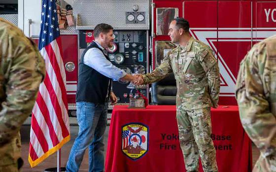 Photo Of U.S. Air Force Tech. Sgt. Preston Castillo, 374th Civil Engineer Squadron section chief assistant chief for health and safety, receives a coin from the Honorable Brendan Owens, Assistant Secretary of Defense for Energy, Installations and Environment, at Yokota Air Base, Japan, Sept. 6, 2024.