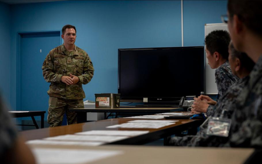 U.S. Air Force Staff Sgt. Brandon Davisson, 374th Logistics Readiness Squadron air transportation specialist, answers a question during a joint inspection training in support of exercise Resolute Force Pacific 2025.
