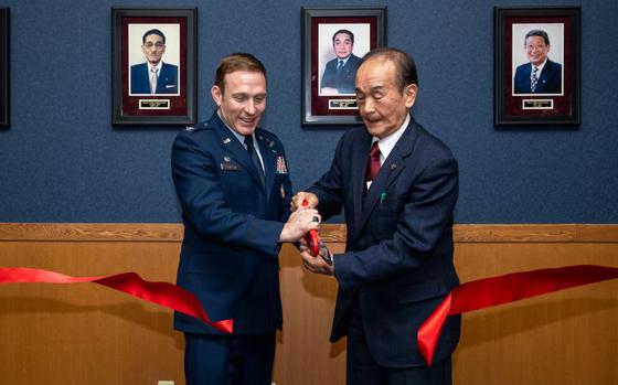 U.S. Air Force Col. Paul Davidson, left, 35th Fighter Wing commander, and Yoshinori Kohiyama, Misawa City mayor, cut a ribbon during the Mayor’s Room Grand Opening Ceremony at Misawa Air Base, Japan