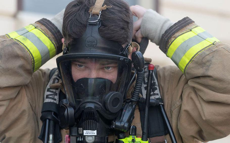 Staff Sgt. Thomas Reno, 374th Civil Engineer Squadron fire truck operator, puts on his fire protection gear during a bilateral training with the Japan Air Self-Defense Force at Yokota Air Base, Japan, Oct. 28, 2022. Practicing standardized firefighting techniques between U.S. and Japanese Airmen gave both sides the opportunity to sharpen joint capabilities and build stronger partnerships. (U.S. Air Force photo by Machiko Arita)