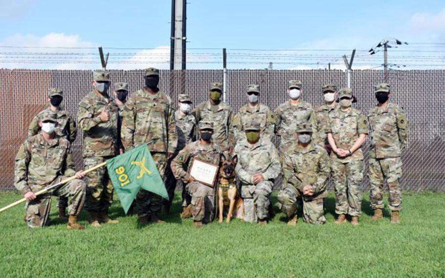 Members of the 901st Military Police Detachment, Lt. Col. Demetrick Thomas and Command Sgt. Maj. Edgar Rodriguez, command team of the 35th Combat Sustainment Support Battalion, as well as Soldiers from the Camp Zama Veterinary Treatment Facility, pose for a photo with Sgt. 1st Class Vito during Vito’s retirement ceremony at Camp Zama, Japan, Sept. 17. (Photo Credit: Winifred Brown)