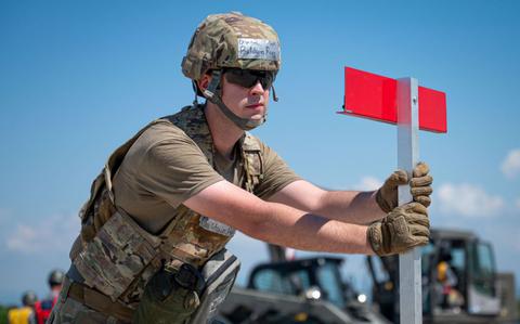 Photo Of U.S. Air Force Senior Airman Rory Baldwin, 374th Civil Engineer Squadron water and fuels systems apprentice, places a marker during a bilateral rapid airfield damage recovery exercise as part of exercise Resolute Force Pacific 2025 at Komatsu Air Base.